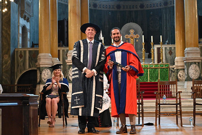Joe Wicks with Vice-Chancellor Anthony McClaran on stage in Westminster Cathedral