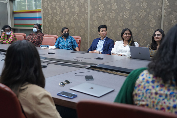 Students listening to lecture at board table