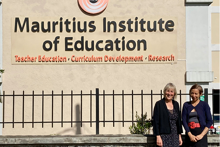 Prof Anna Lise Gordon stood to right of Mauritius Institute of Education sign with representative from the institution