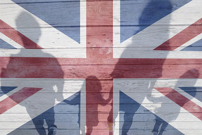 shadows casting of a man, a woman and two children of the union jack