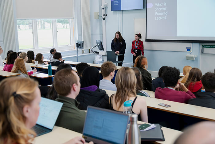 students speaking to school pupils in lecture theatre