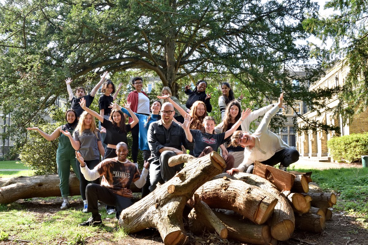 Young students pose excitedly for the camera within the grounds of St Mary's University.