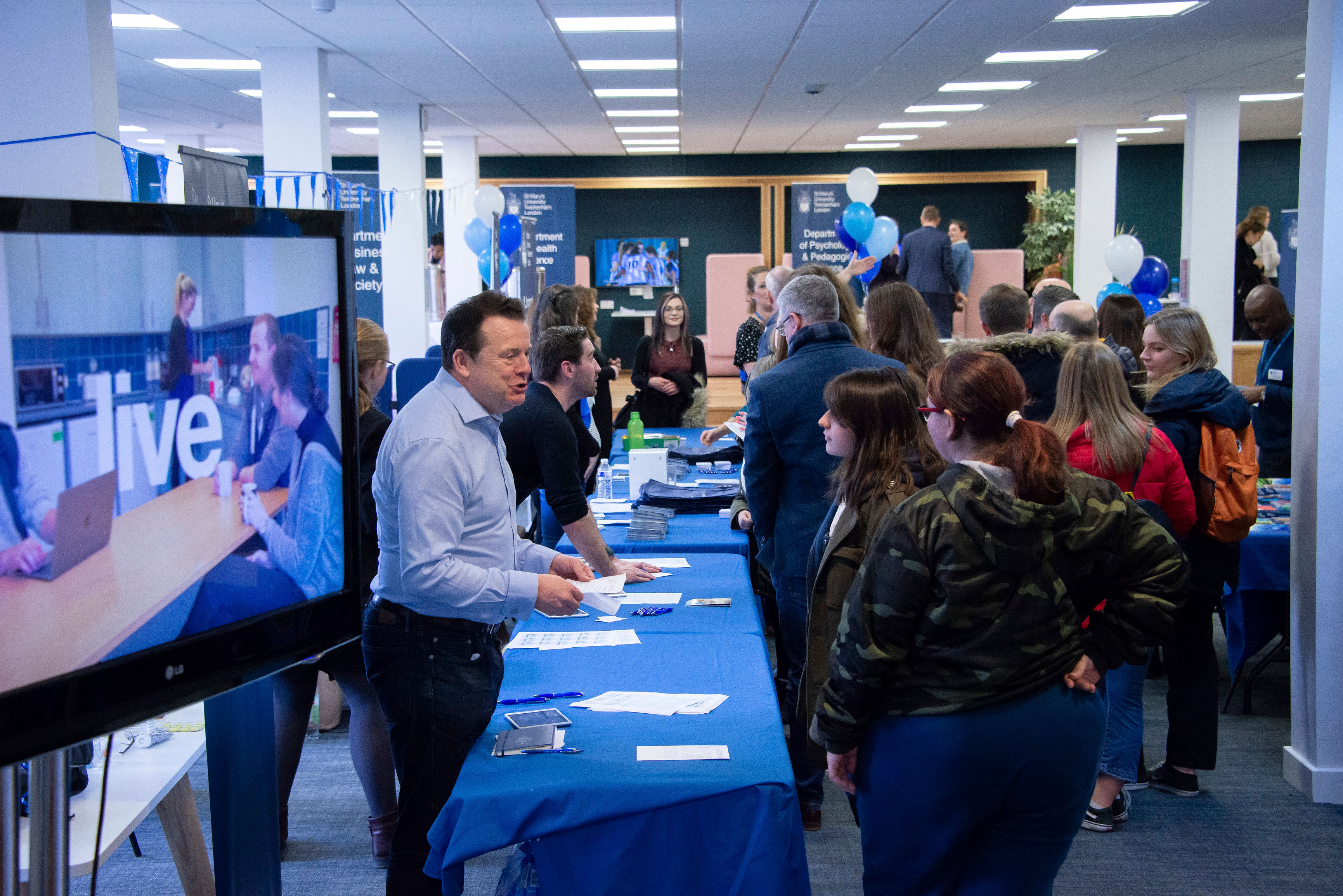 Prospective students being greeted at the registration desk at a St Mary's University Open Day