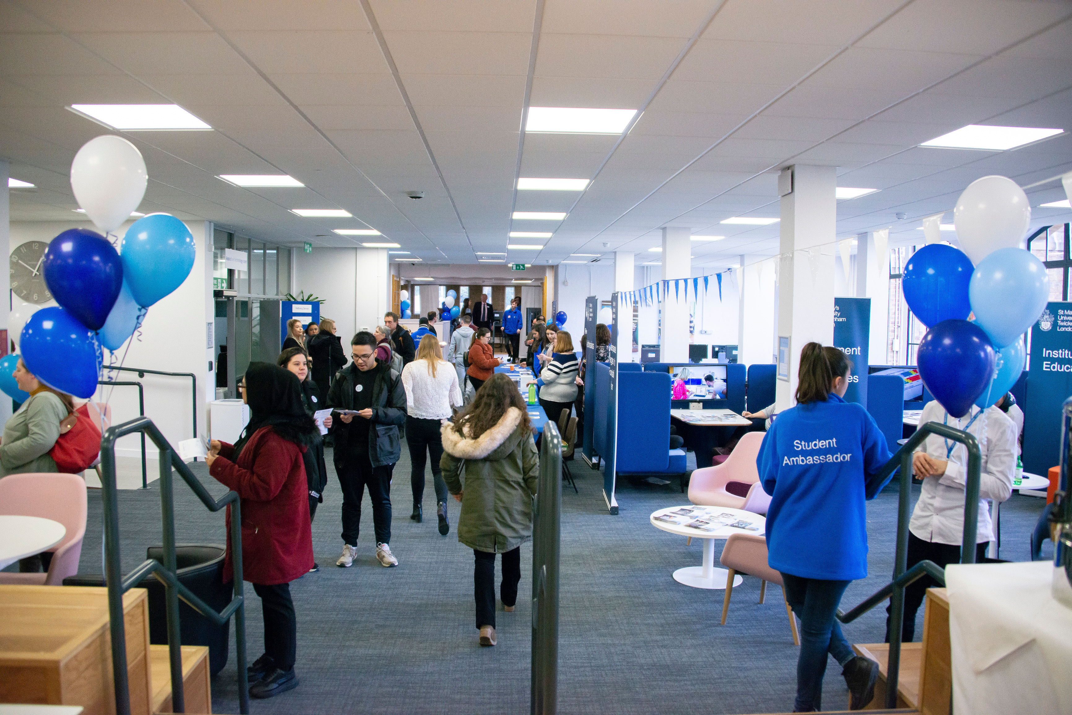 The library decorated for St Mary's University Open Day with people checking in at the registration desk