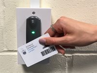 Student tapping their ID card at an attendance card reader