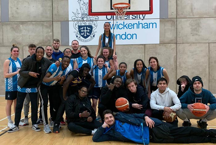 Team photo of the basketball team on court